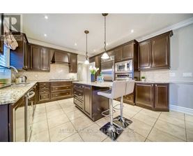 A kitchen with brown cabinets and a granite countertop.