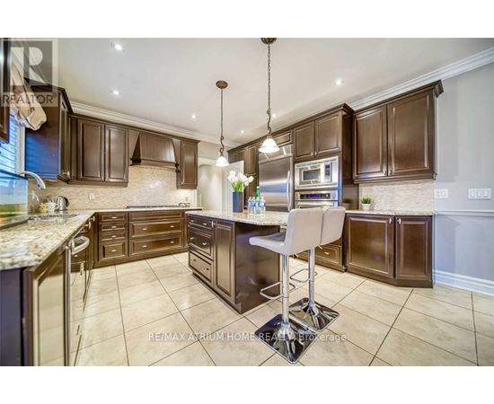 A kitchen with brown cabinets and a granite countertop.