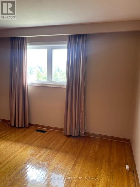 A room with a window and curtains.