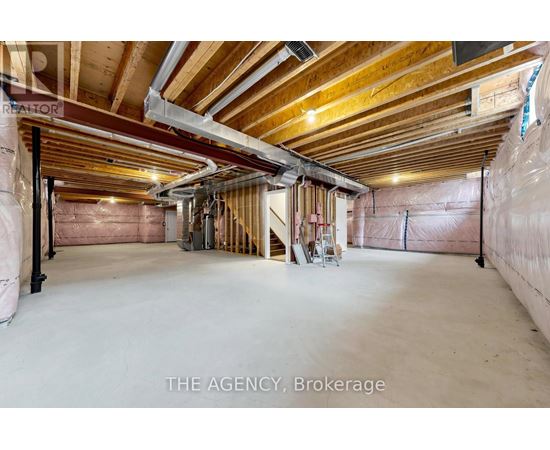 A spacious unfinished room with wooden beams on the ceiling.
