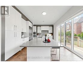 A modern kitchen with white cabinets and a large island.