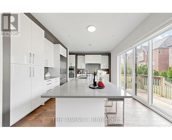 A modern kitchen with white cabinets and a large island.