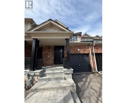 A house with a black front door and a stone staircase leading to the entrance.