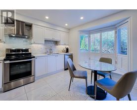 A modern kitchen with a glass table and chairs.