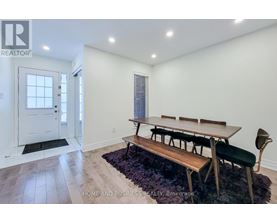 A dining room with a bench seat and a table with chairs.