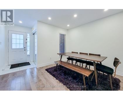 A dining room with a bench seat and a table with chairs.