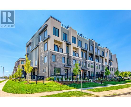 A modern apartment building with a clear blue sky in the background.