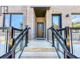 A brick building with a glass railing and a door.