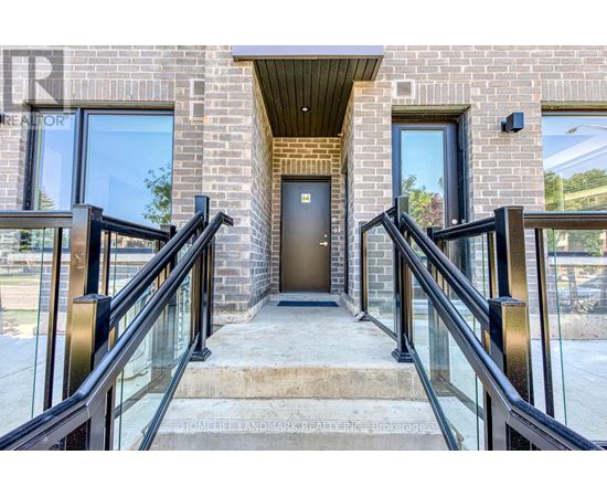 A brick building with a glass railing and a door.