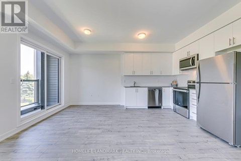 A spacious kitchen with white cabinets and stainless steel appliances.