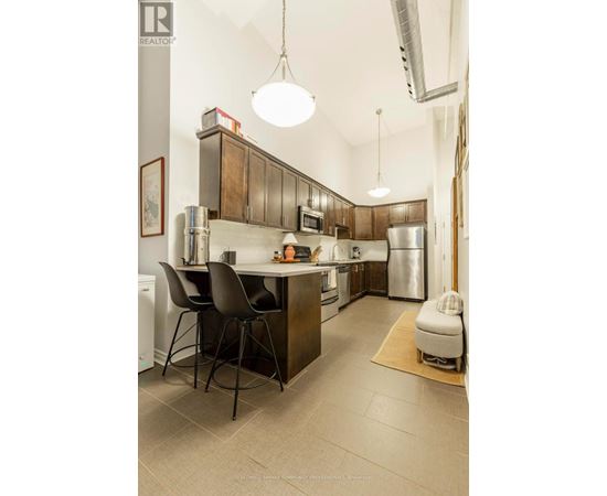 A kitchen with a table and chairs.