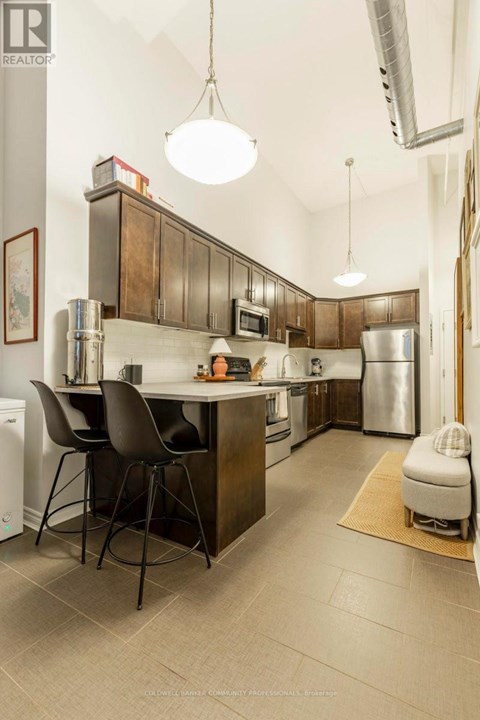 A kitchen with a table and chairs.