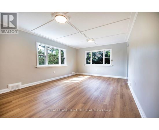 A room with wooden floors and white walls.