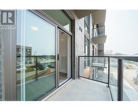 A balcony with glass doors leading to a building.