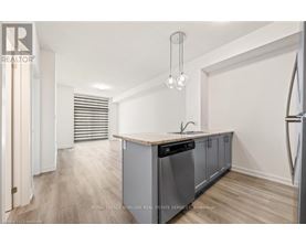 A kitchen with a wooden counter top and stainless steel appliances.