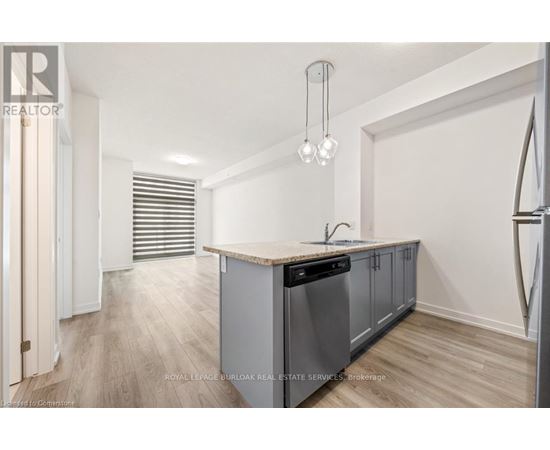 A kitchen with a wooden counter top and stainless steel appliances.