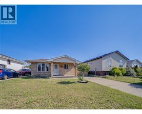 A house with a car parked in front is for sale.
