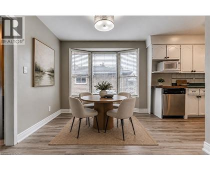 A dining room with a table set for four.