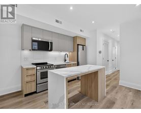 A modern kitchen with a white island in the middle.