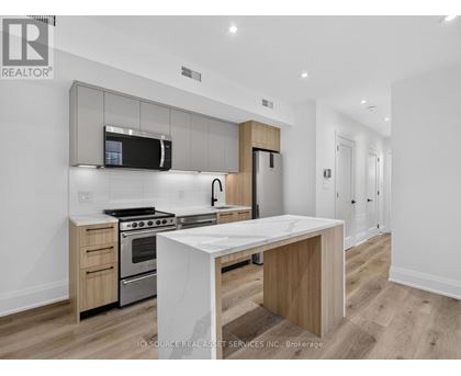 A modern kitchen with a white island in the middle.