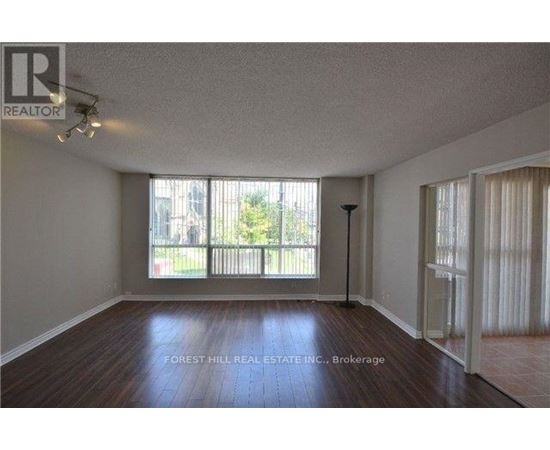 A room with a sliding glass door leading to a balcony.
