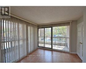 A room with a sliding glass door and a tiled floor.