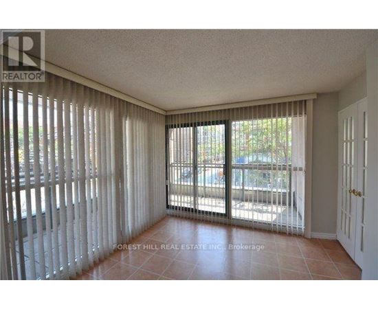 A room with a sliding glass door and a tiled floor.