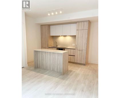 A modern kitchen with wooden cabinets and a central island.