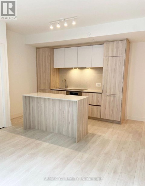 A modern kitchen with wooden cabinets and a central island.