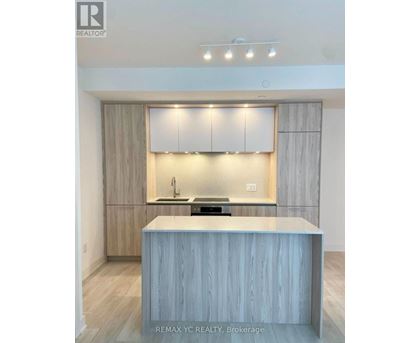 A modern kitchen with a large island in the middle.