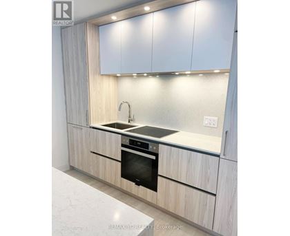 A modern kitchen with a sink and stove.
