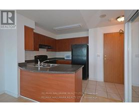 A kitchen with a sink and a refrigerator.