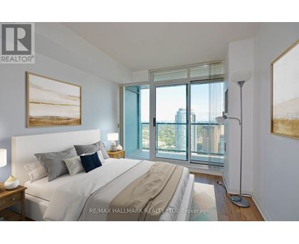 A bedroom with a large bed and a view of the city.