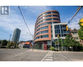 A modern building with a curved facade is the main focus of the image.