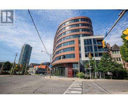 A modern building with a curved facade is the main focus of the image.