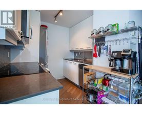 A kitchen with a stove top oven and a refrigerator.