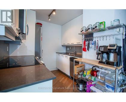 A kitchen with a stove top oven and a refrigerator.