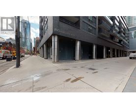 A street view of a building with the sign 295 Adelaide St.