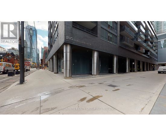 A street view of a building with the sign 295 Adelaide St.