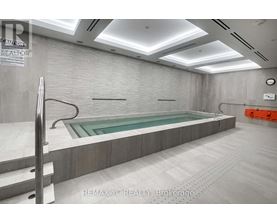 A large indoor swimming pool with a glass bottom.