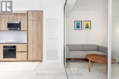 A living room with a grey couch and a wooden coffee table.