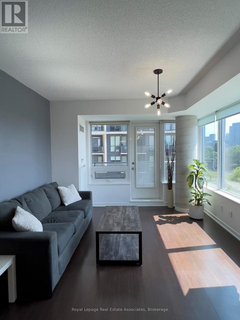 A living room with a grey couch and a coffee table.
