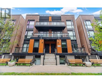 A modern apartment building with a black and orange facade.