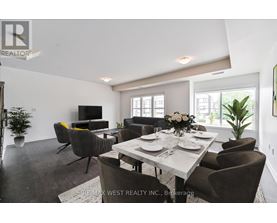 A dining room with a table set for six and a television.