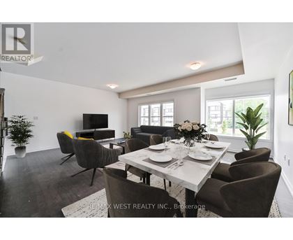 A dining room with a table set for six and a television.
