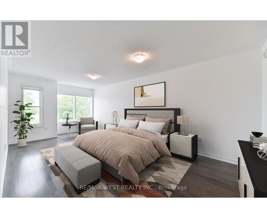 A bedroom with a large bed and a plant in the corner.