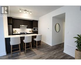 A kitchen with white chairs and a white counter top.