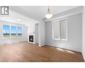 A well-lit, spacious room with a fireplace and a view of the outdoors through the windows.