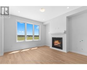 A living room with a fireplace and a large window.