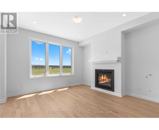A living room with a fireplace and a large window.